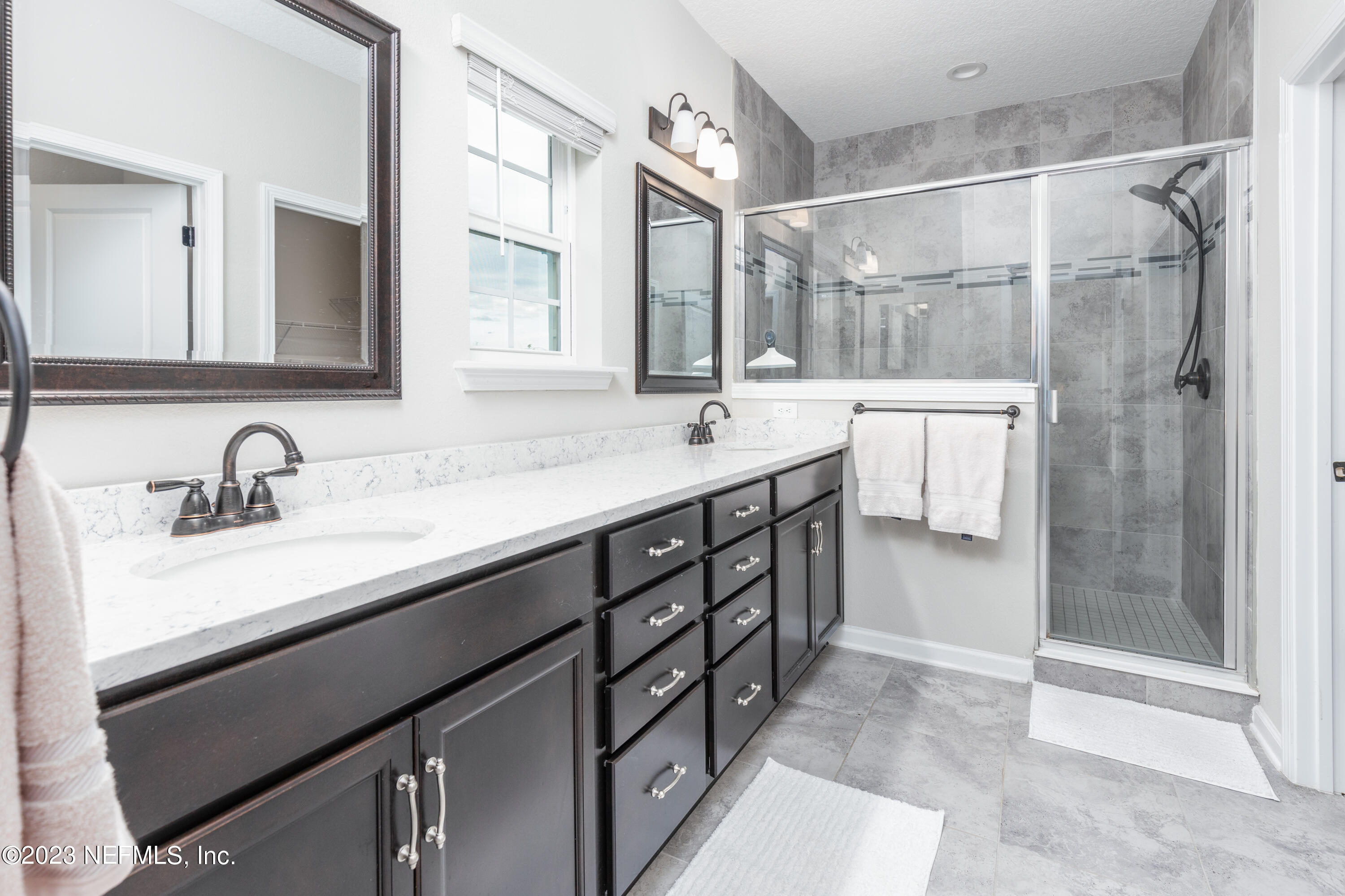 400 Weathered Edge Drive St. Augustine, FL 32092 - Photo 13 of 35 a bathroom with a sink double vanity and a shower