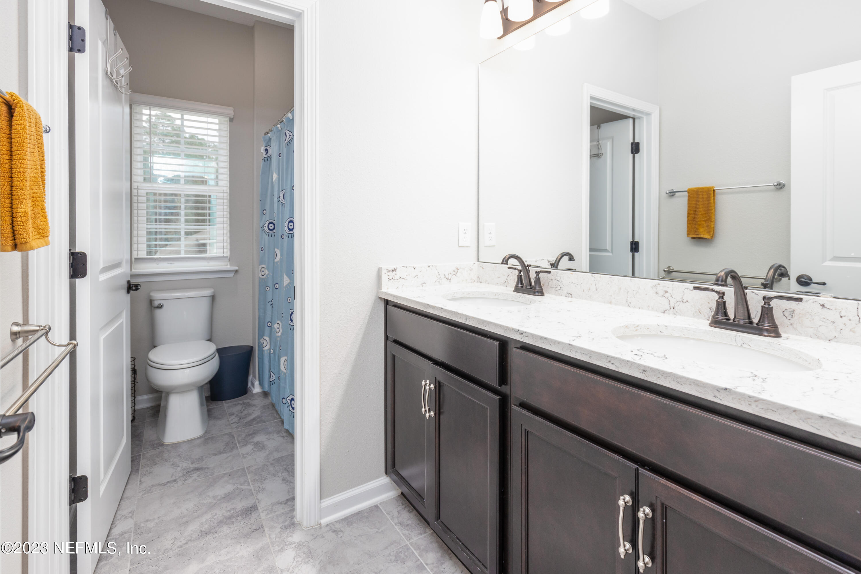 400 Weathered Edge Drive St. Augustine, FL 32092 - Photo 15 of 35 a bathroom with a sink a toilet and a mirror