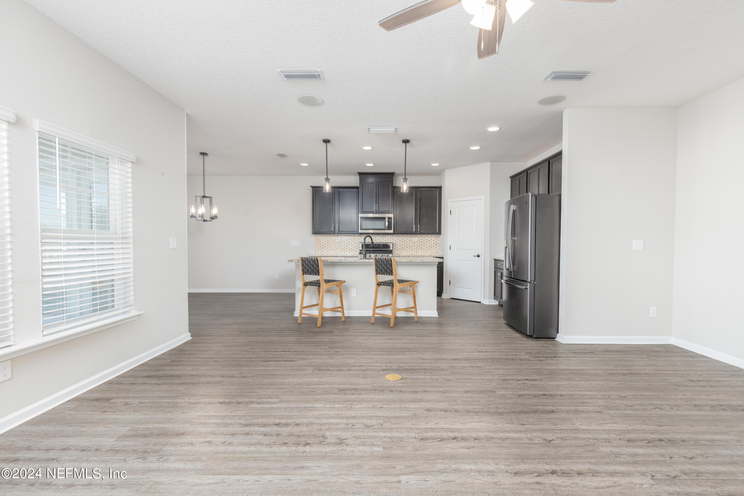 400 Weathered Edge Drive St. Augustine, FL 32092 - Photo 22 of 35 a view of kitchen with stainless steel appliances refrigerator oven dining table and chairs