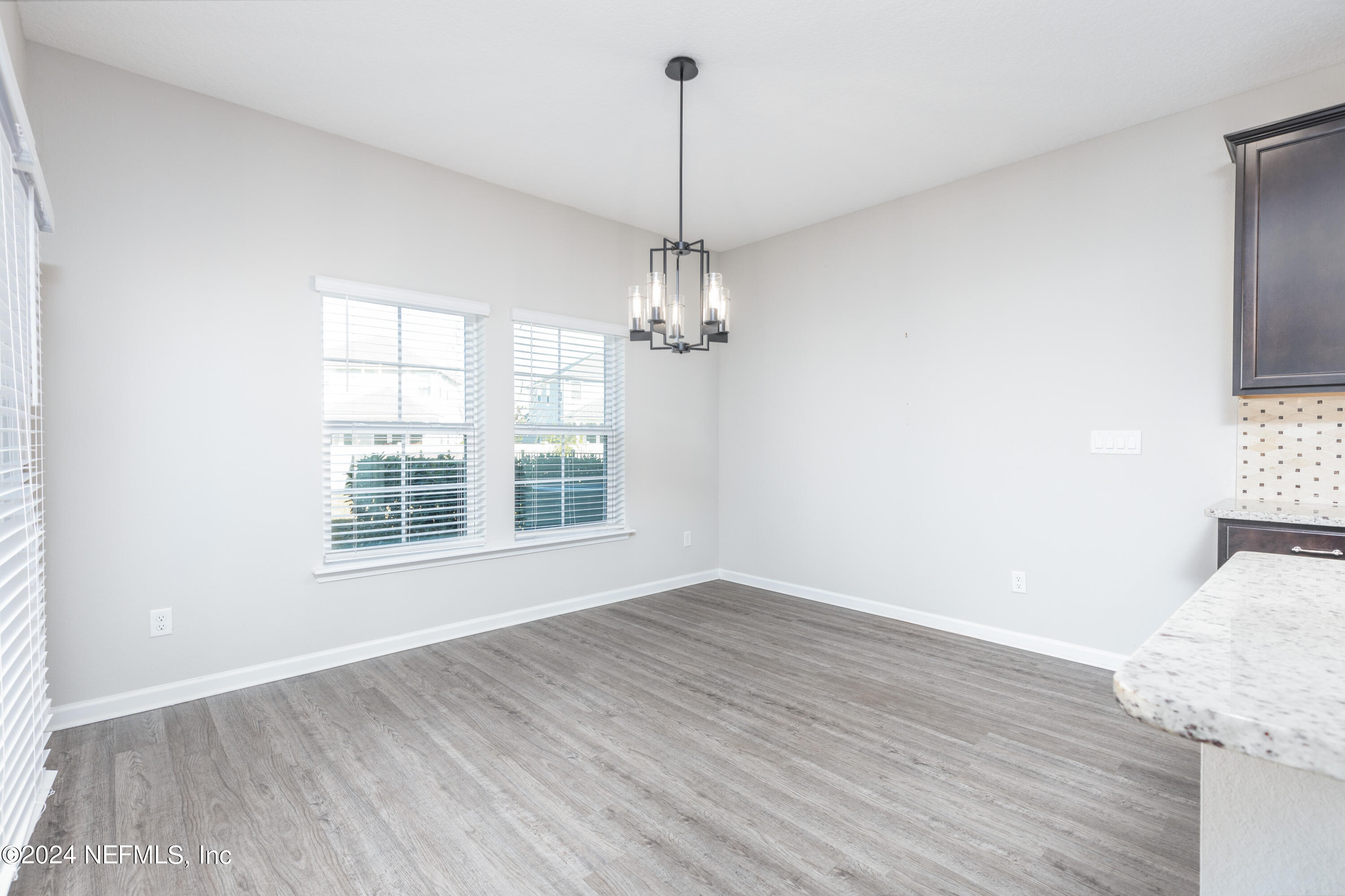 400 Weathered Edge Drive St. Augustine, FL 32092 - Photo 23 of 35 a view of a room with wooden floor chandelier and windows