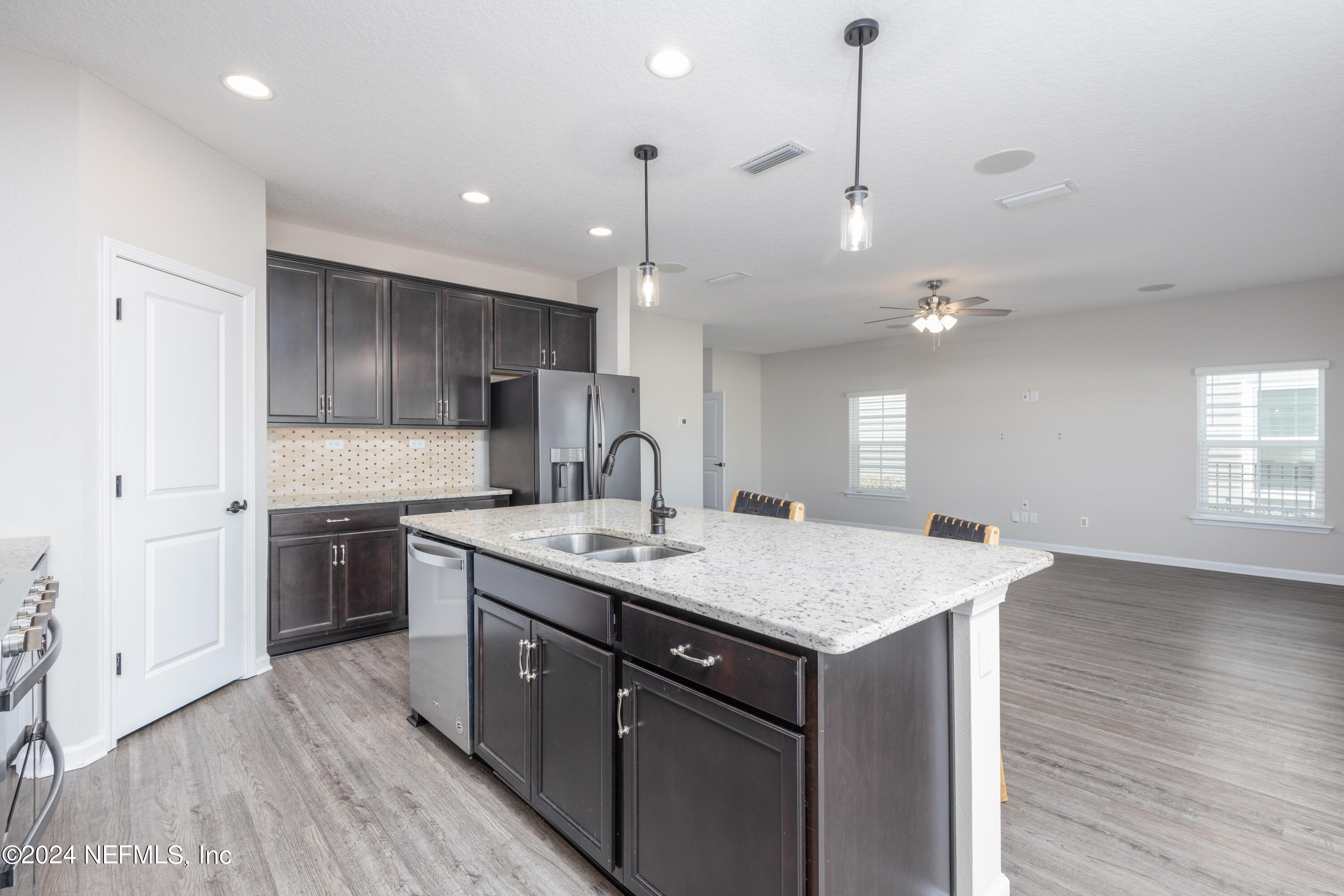 400 Weathered Edge Drive St. Augustine, FL 32092 - Photo 25 of 35 a kitchen with a sink chandelier and wooden floor