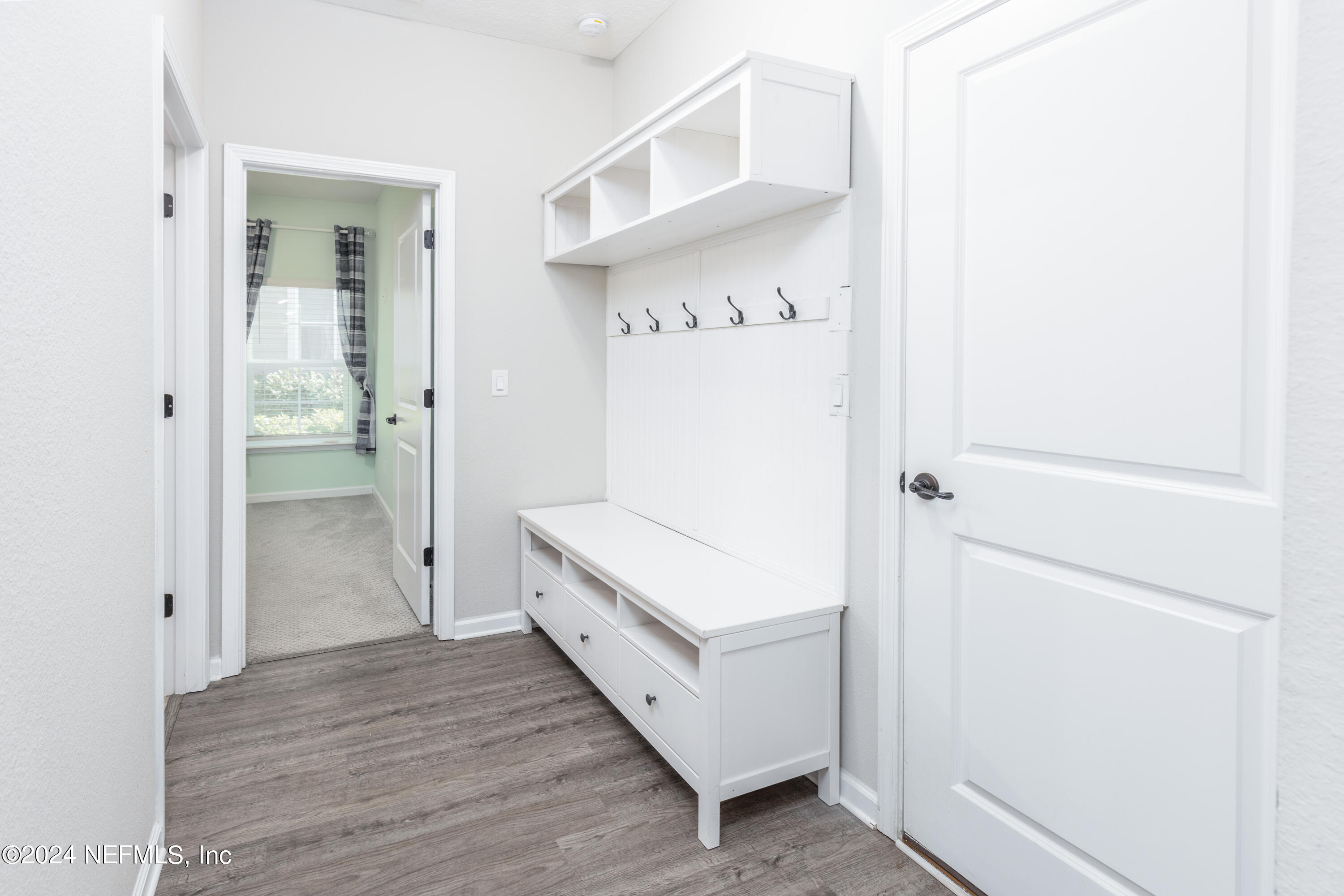 400 Weathered Edge Drive St. Augustine, FL 32092 - Photo 7 of 35 a view of a hallway with closet and wooden floor