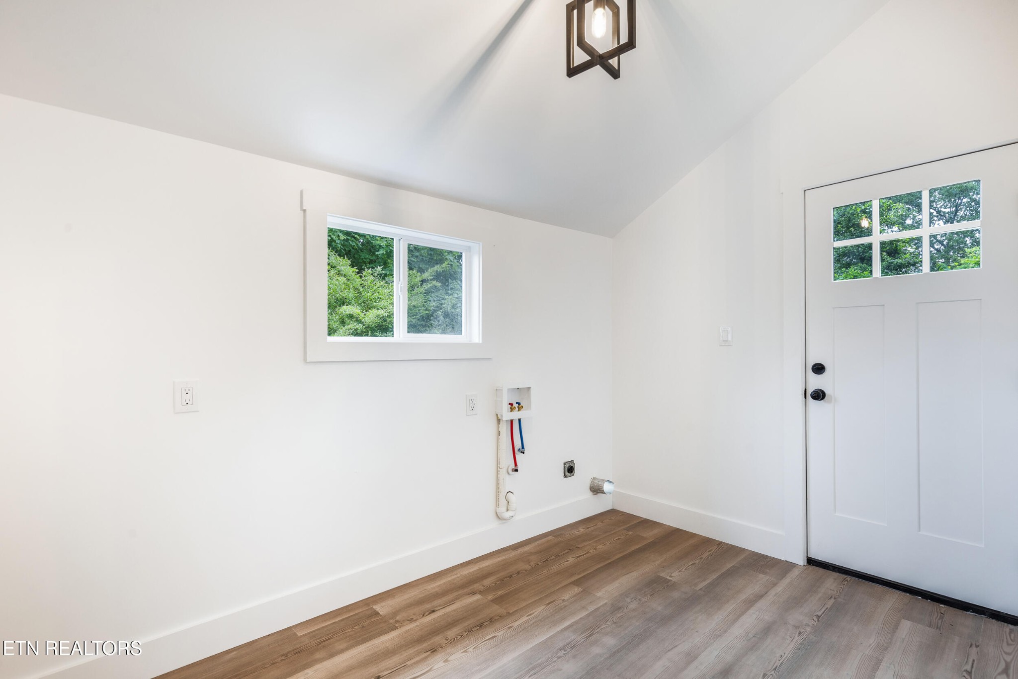 207 Shipe Road Powell, TN 37849 - Photo 13 of 23 an empty room with wooden floor and windows