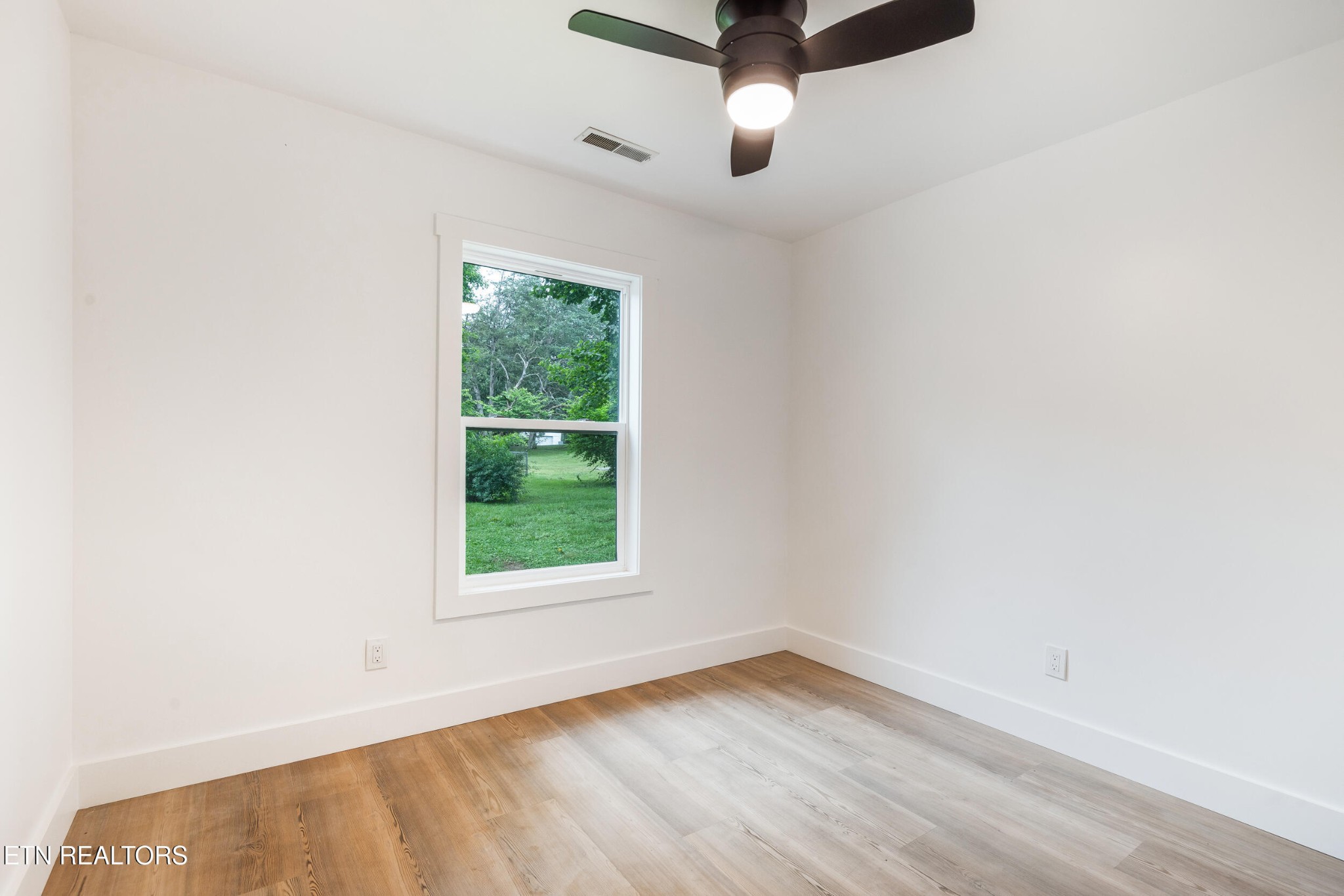 207 Shipe Road Powell, TN 37849 - Photo 15 of 23 an empty room with a window and wooden floor