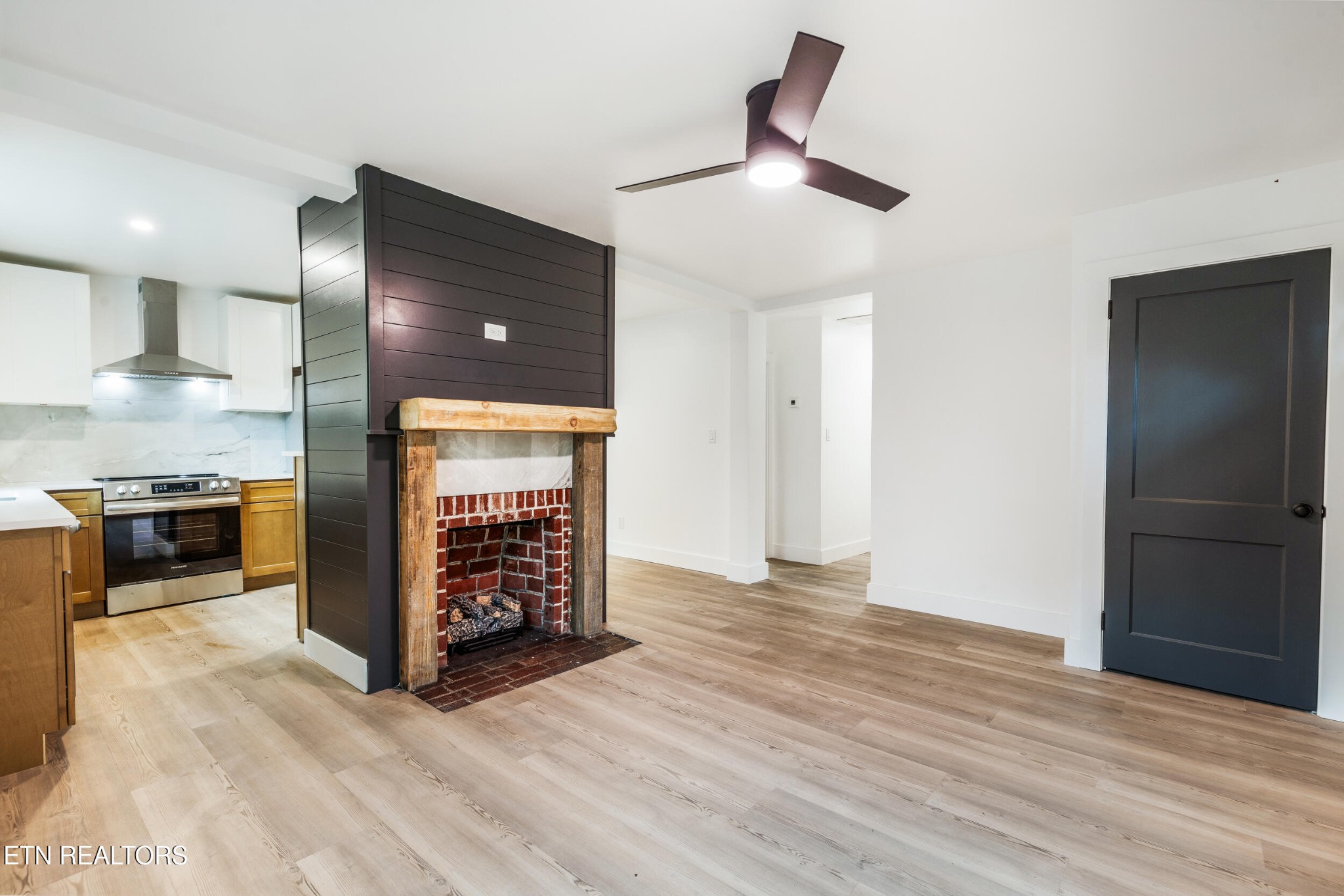 207 Shipe Road Powell, TN 37849 - Photo 7 of 23 a view of a livingroom with a kitchen and a stove