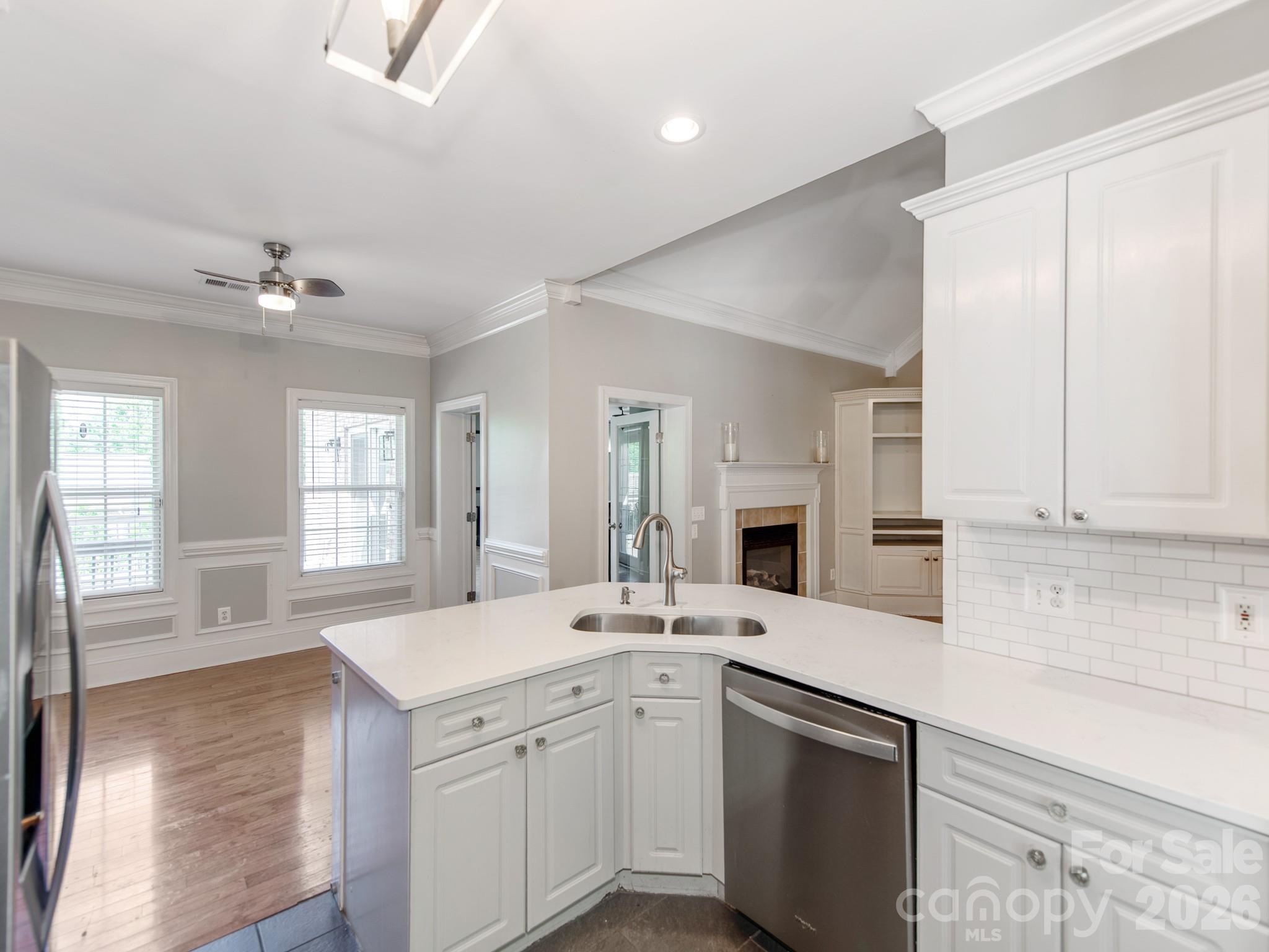 783 Sloan Street Denver, NC 28037 - Photo 9 of 44 a kitchen with a sink stove and cabinets
