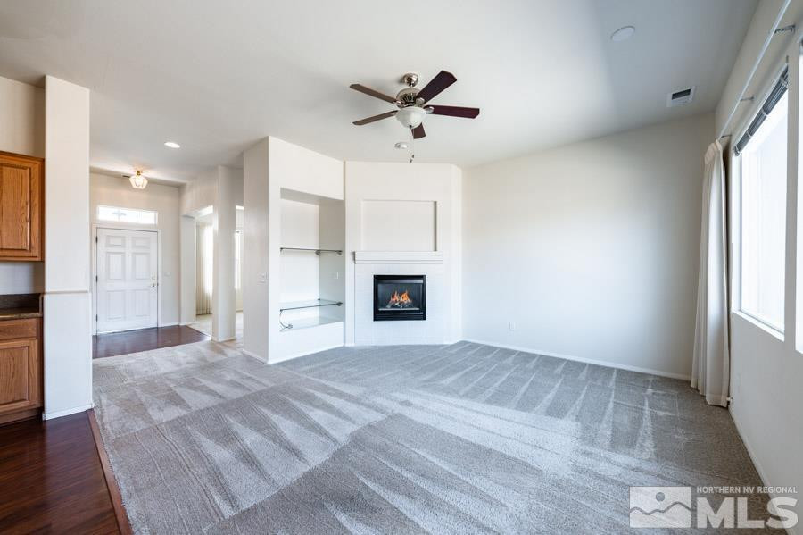 1487 Wild Wolf Way Reno, NV 89521 - Photo 13 of 39 a view of an empty room with a fireplace and a window