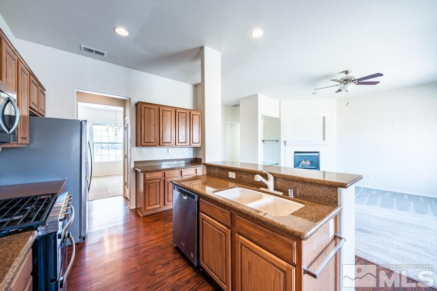 1487 Wild Wolf Way Reno, NV 89521 - Photo 19 of 39 a kitchen with stainless steel appliances granite countertop a sink stove and refrigerator