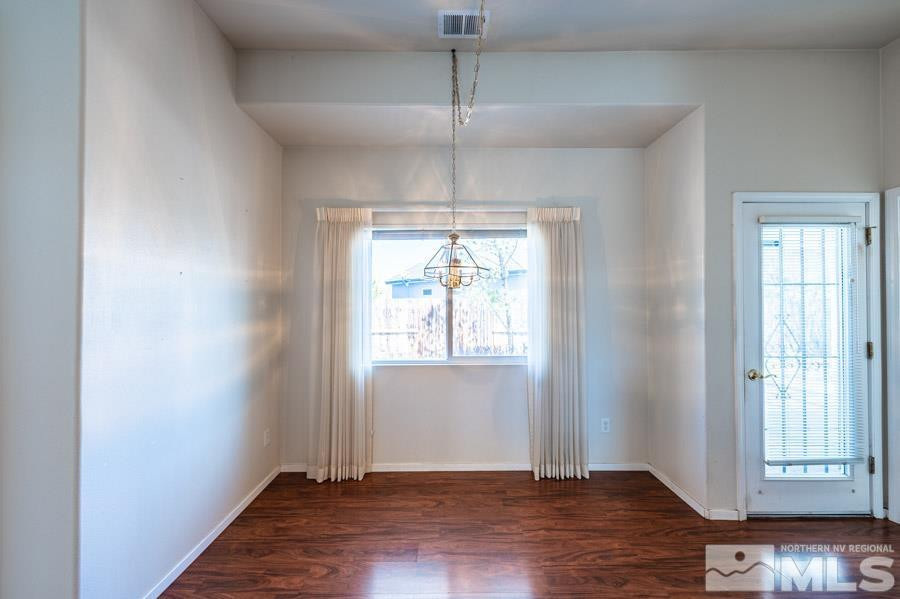 1487 Wild Wolf Way Reno, NV 89521 - Photo 20 of 39 an empty room with wooden floor and windows