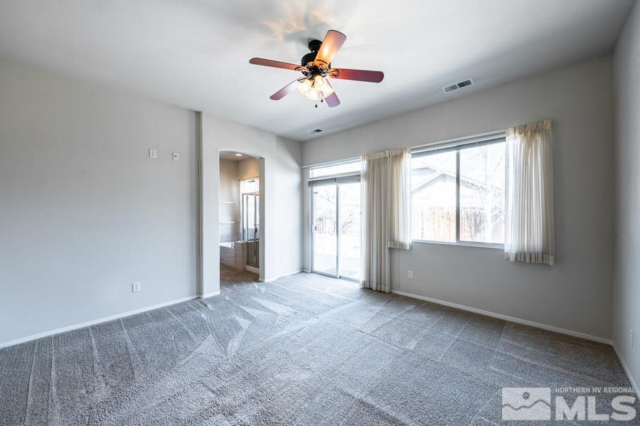 1487 Wild Wolf Way Reno, NV 89521 - Photo 23 of 39 a view of n empty room with window and a ceiling fan
