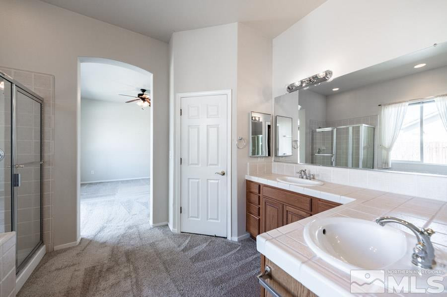 1487 Wild Wolf Way Reno, NV 89521 - Photo 25 of 39 a bathroom with a tub sink and mirror
