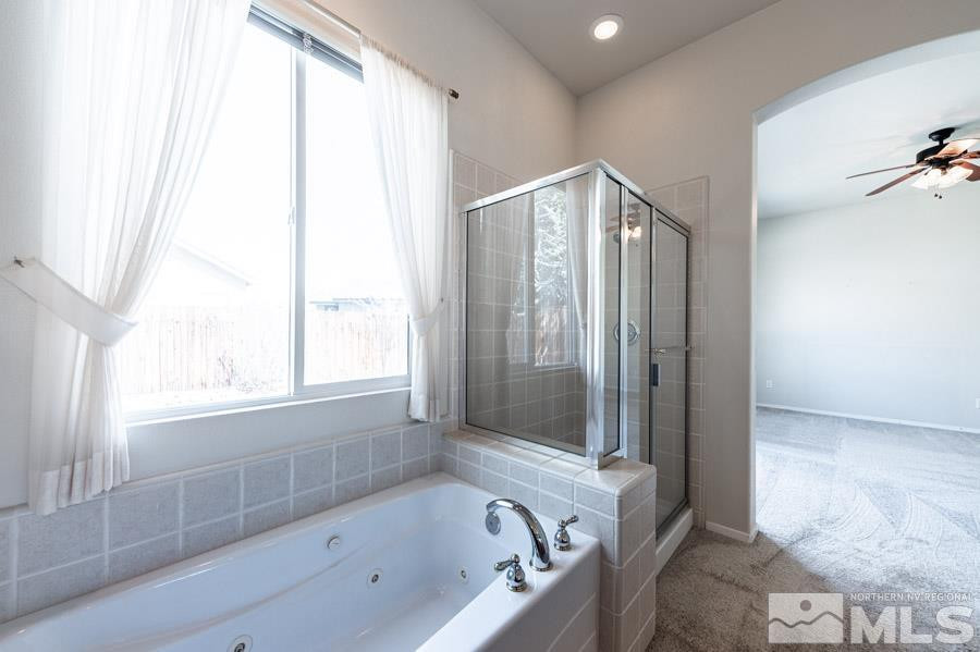 1487 Wild Wolf Way Reno, NV 89521 - Photo 26 of 39 a bathroom with a bathtub and a shower