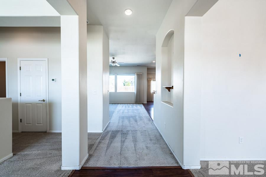 1487 Wild Wolf Way Reno, NV 89521 - Photo 6 of 39 a view of a hallway with wooden floor and a living room