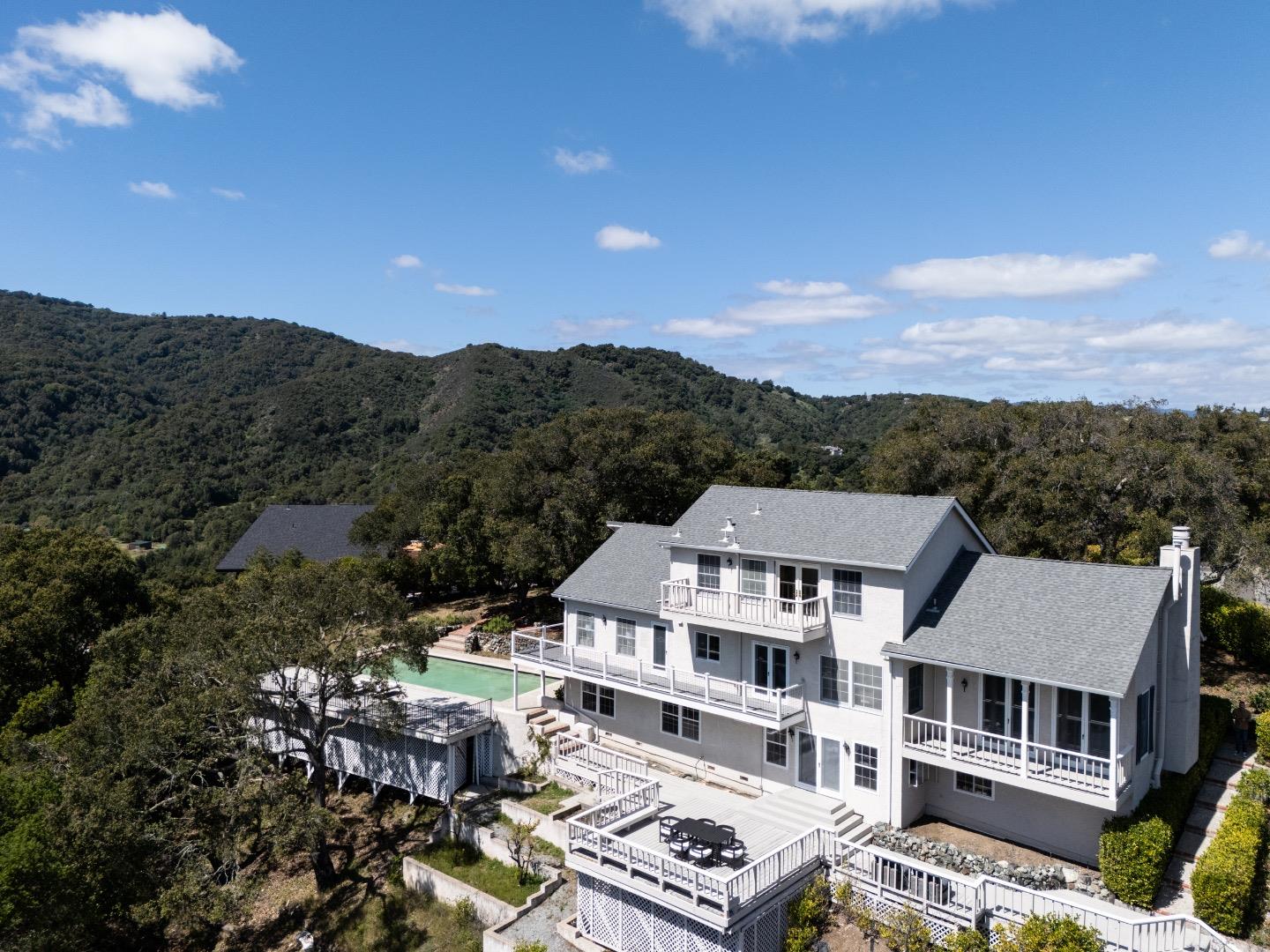an aerial view of residential houses with a city view