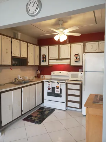 a kitchen with stainless steel appliances granite countertop a sink and cabinets