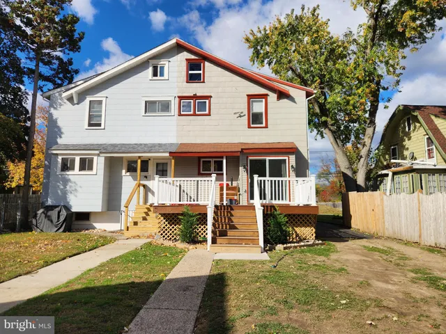 a front view of a house with a yard outdoor seating and pathway