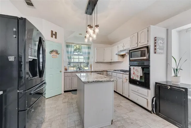a kitchen with a refrigerator sink and stove