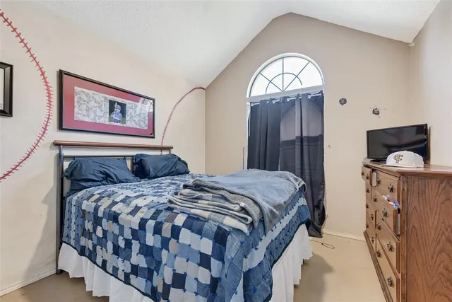 a bedroom with a bed and a flat screen television