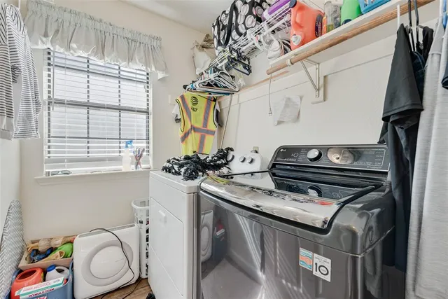 a utility room with a stove a washer and dryer