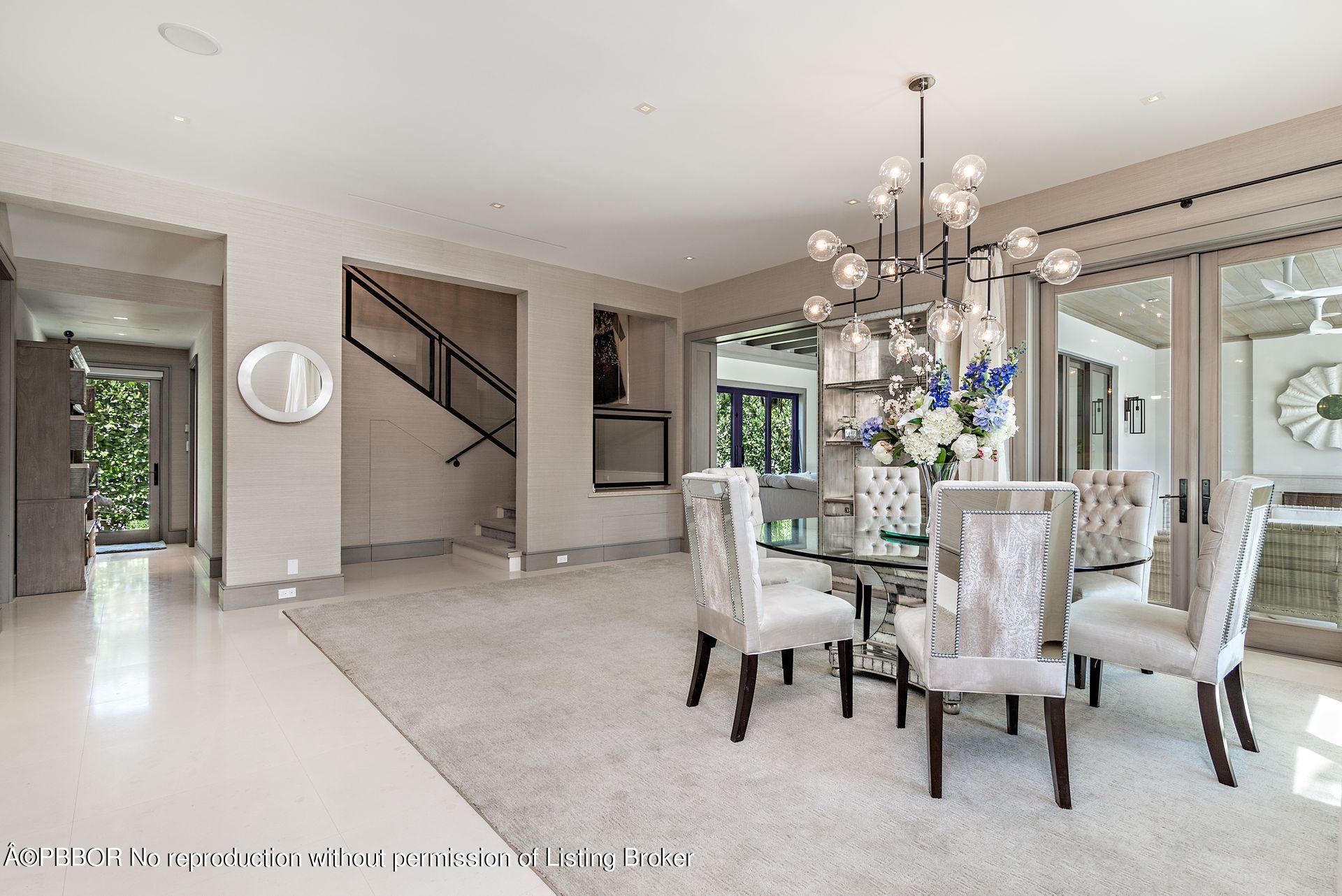325 Garden Road Palm Beach, FL 33480 - Photo 19 of 57 a view of a dining room with furniture and chandelier