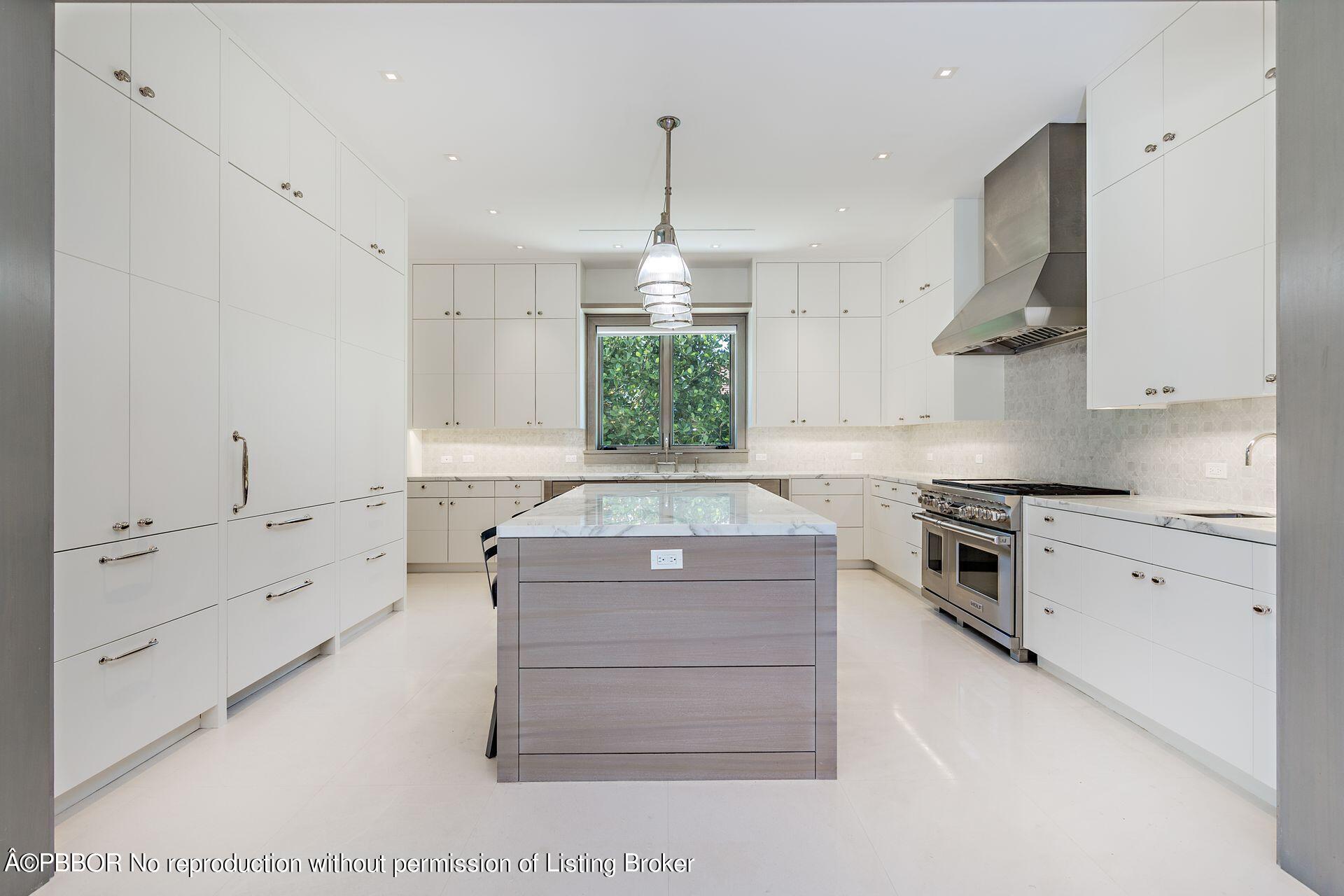 325 Garden Road Palm Beach, FL 33480 - Photo 21 of 57 a kitchen with a stove a sink and a refrigerator