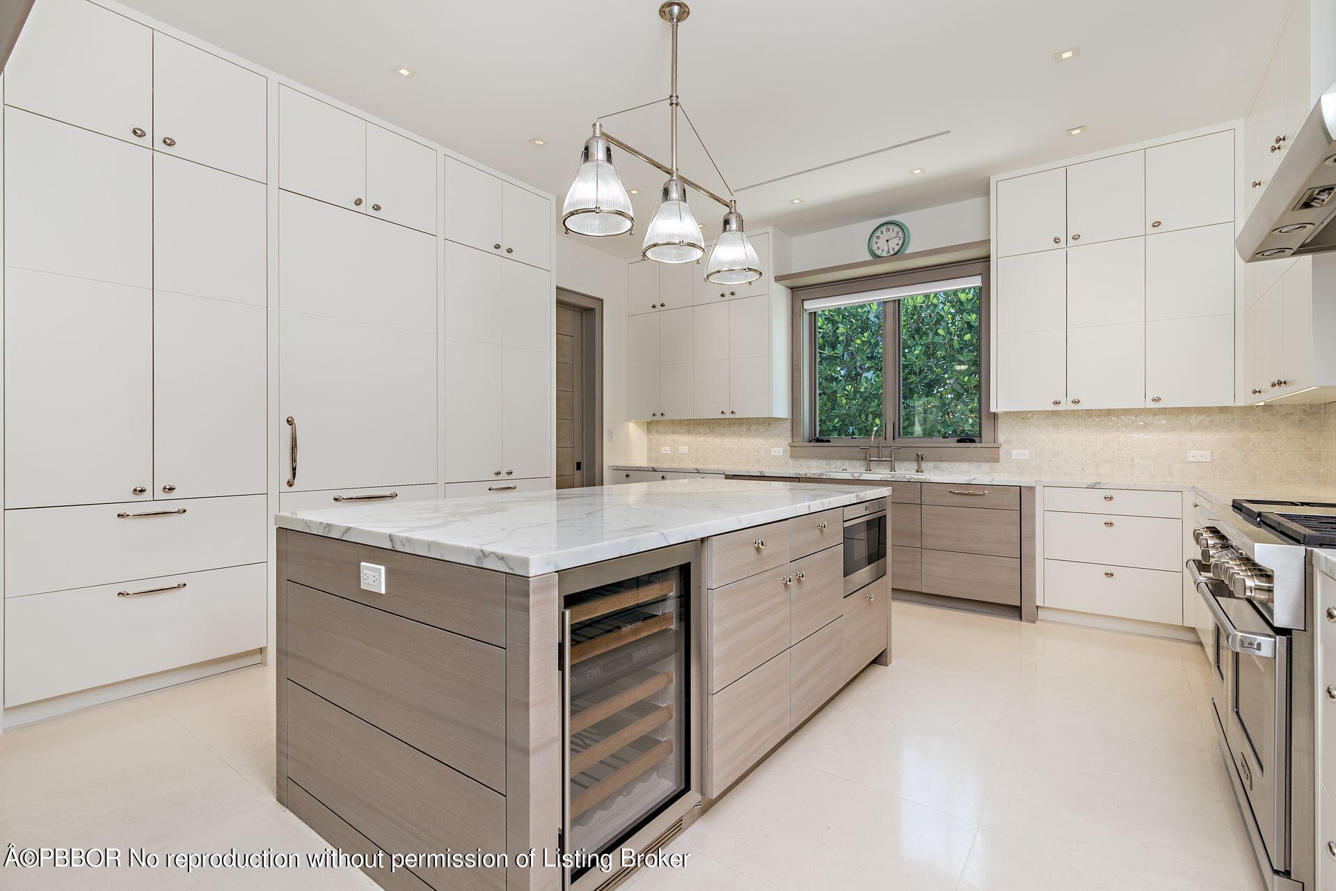 325 Garden Road Palm Beach, FL 33480 - Photo 23 of 57 a kitchen with a stove window and cabinets