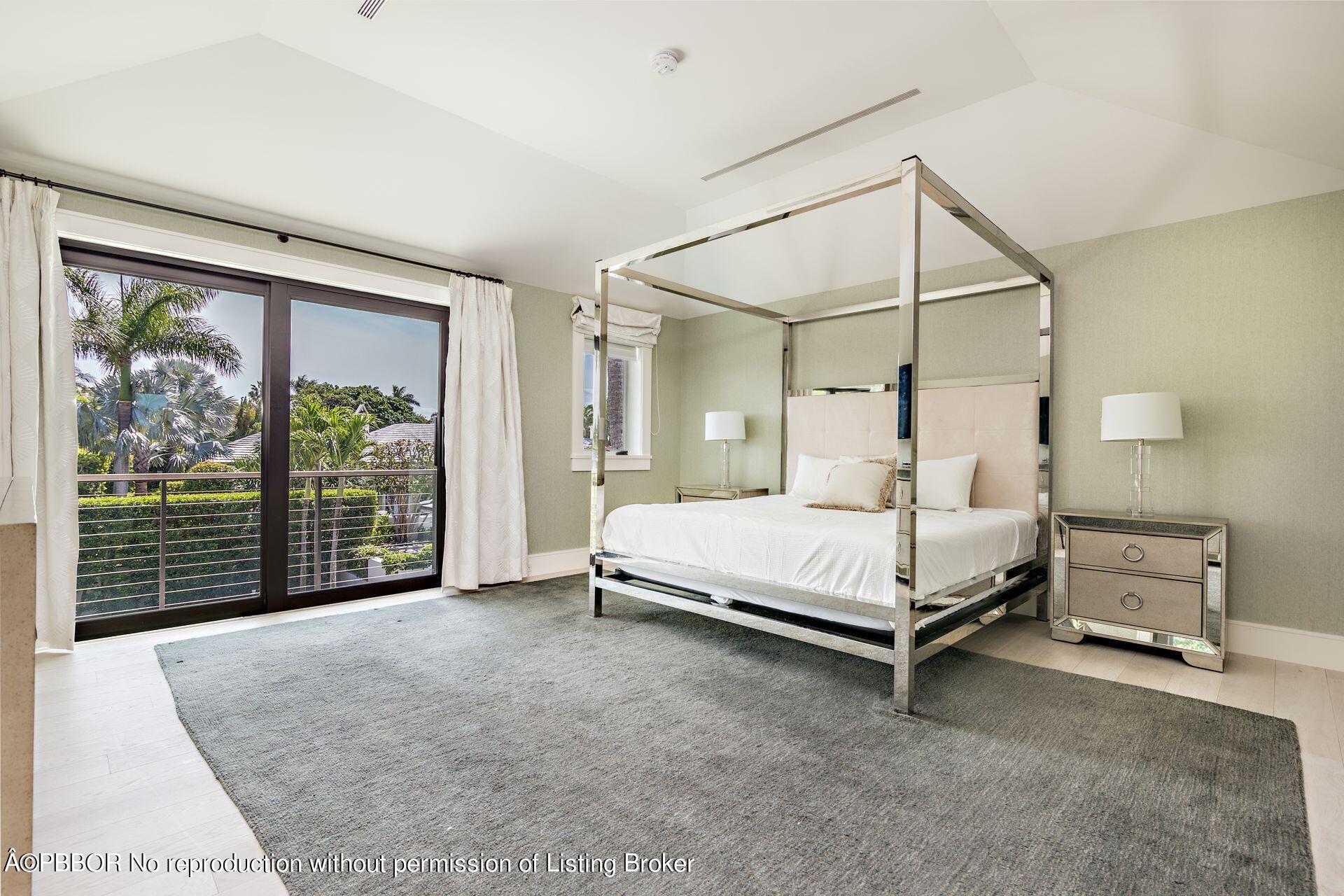325 Garden Road Palm Beach, FL 33480 - Photo 27 of 57 a bedroom with a bed and large window