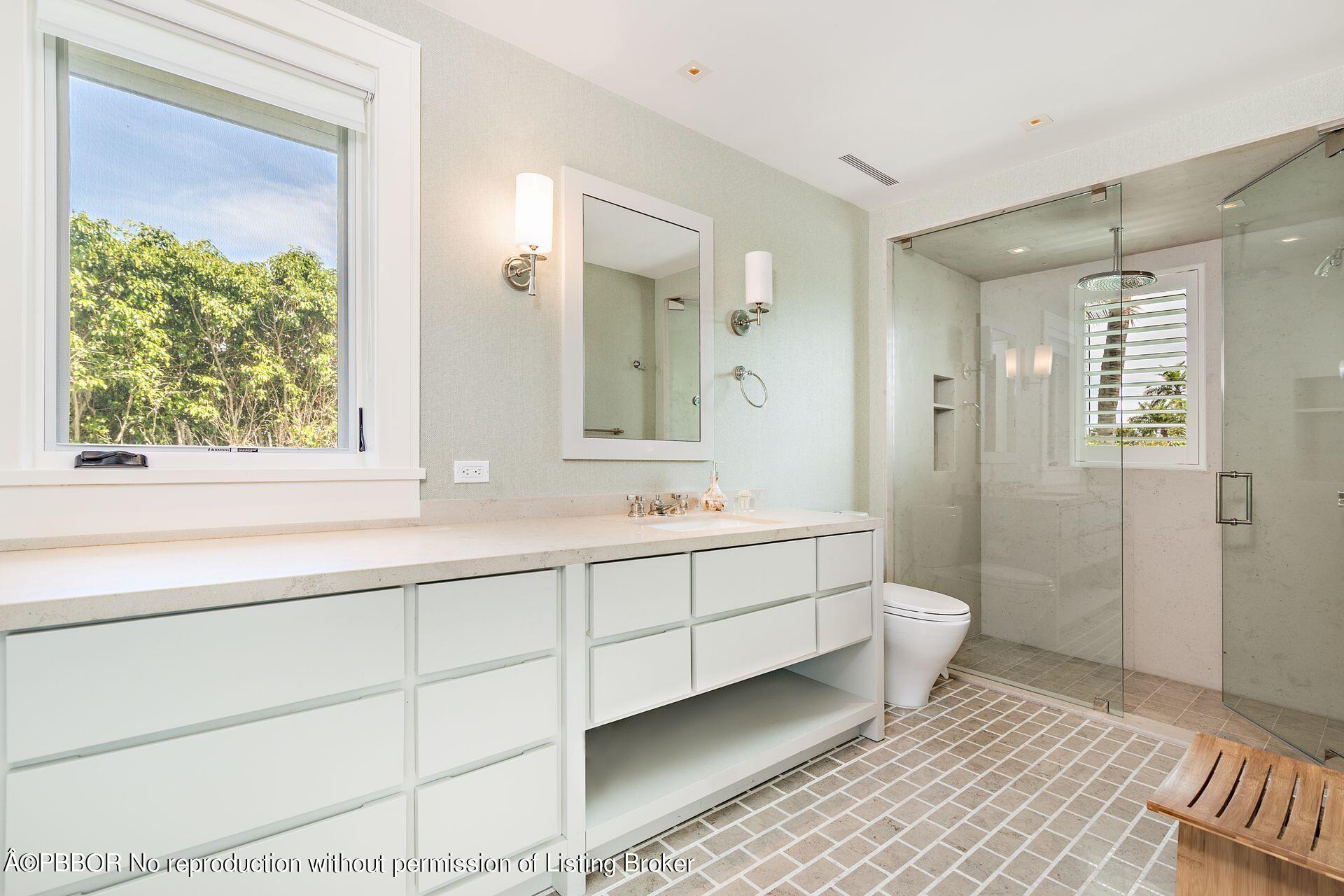 325 Garden Road Palm Beach, FL 33480 - Photo 28 of 57 a bathroom with a double vanity sink toilet and shower