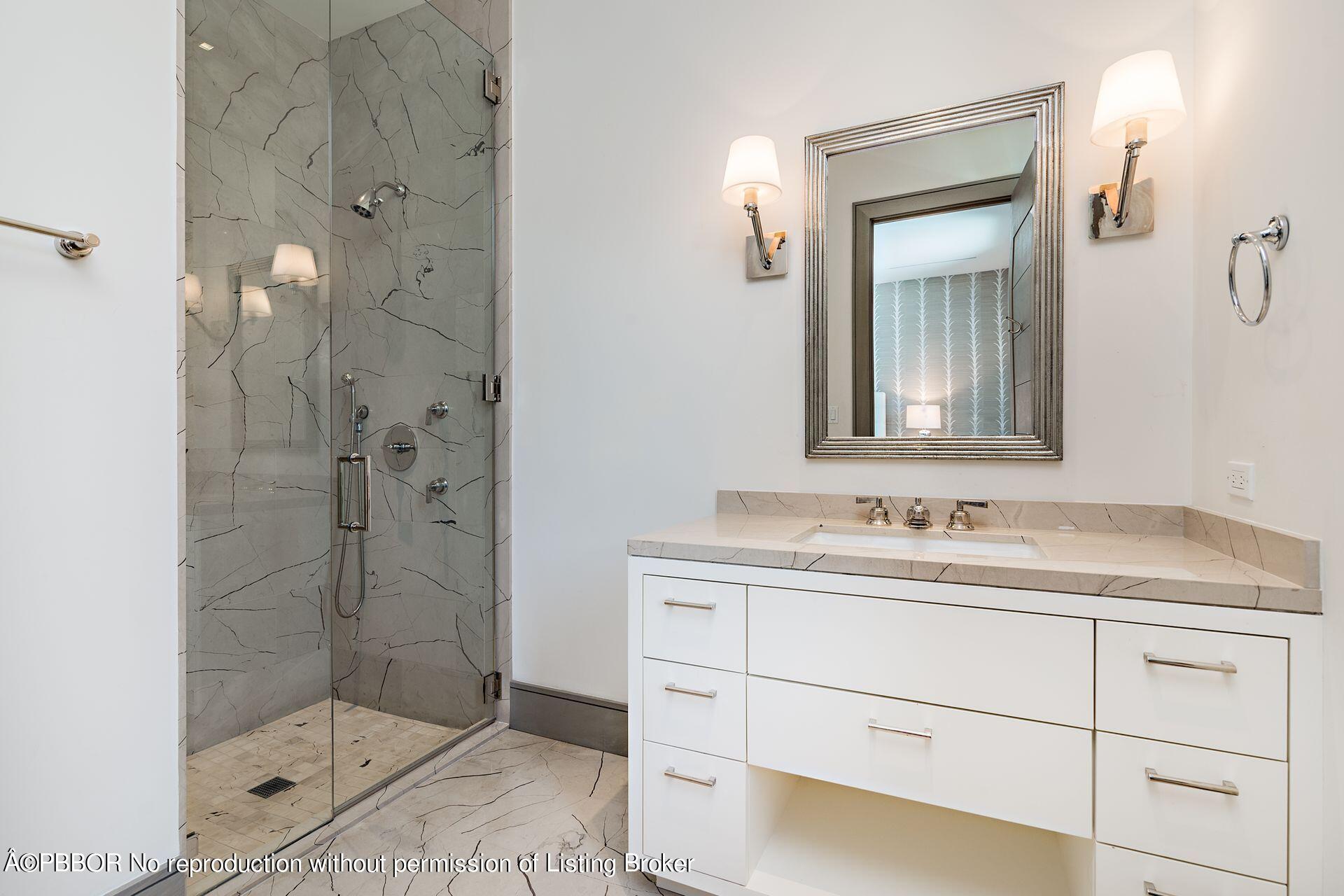 325 Garden Road Palm Beach, FL 33480 - Photo 31 of 57 a bathroom with a shower sink and mirror