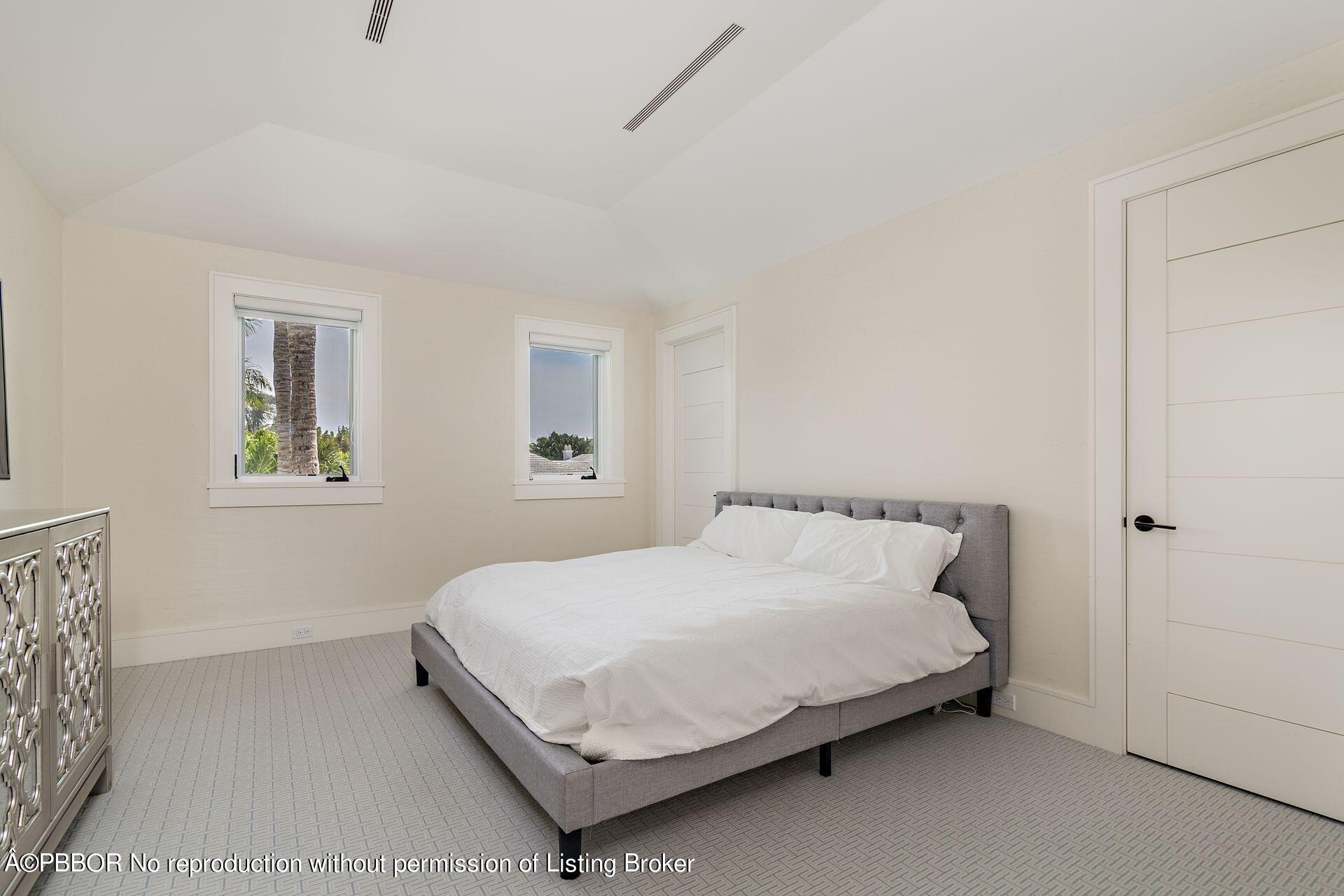 325 Garden Road Palm Beach, FL 33480 - Photo 32 of 57 a bedroom with a bed and window