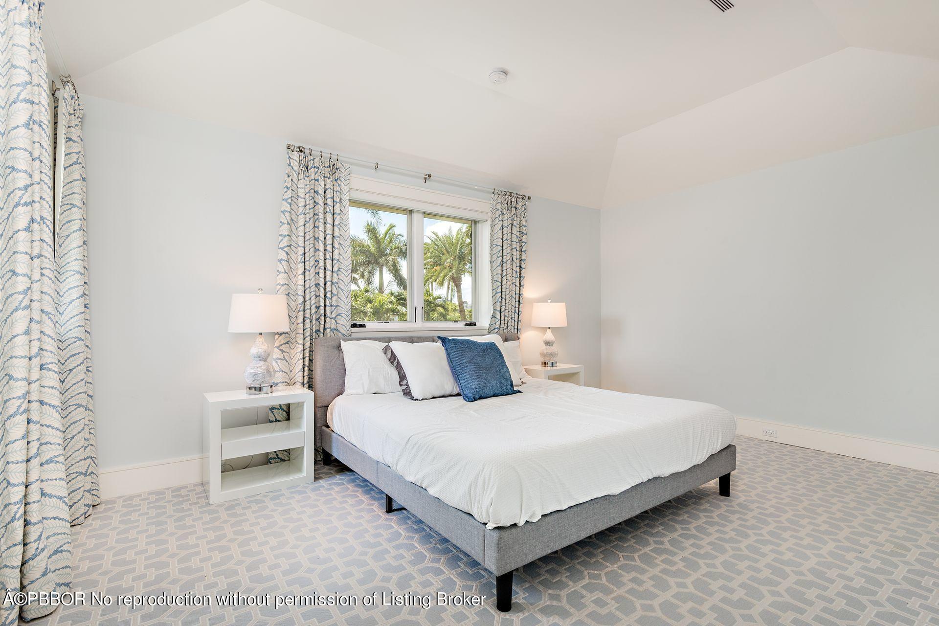 325 Garden Road Palm Beach, FL 33480 - Photo 35 of 57 a bedroom with a bed lamp and a large window
