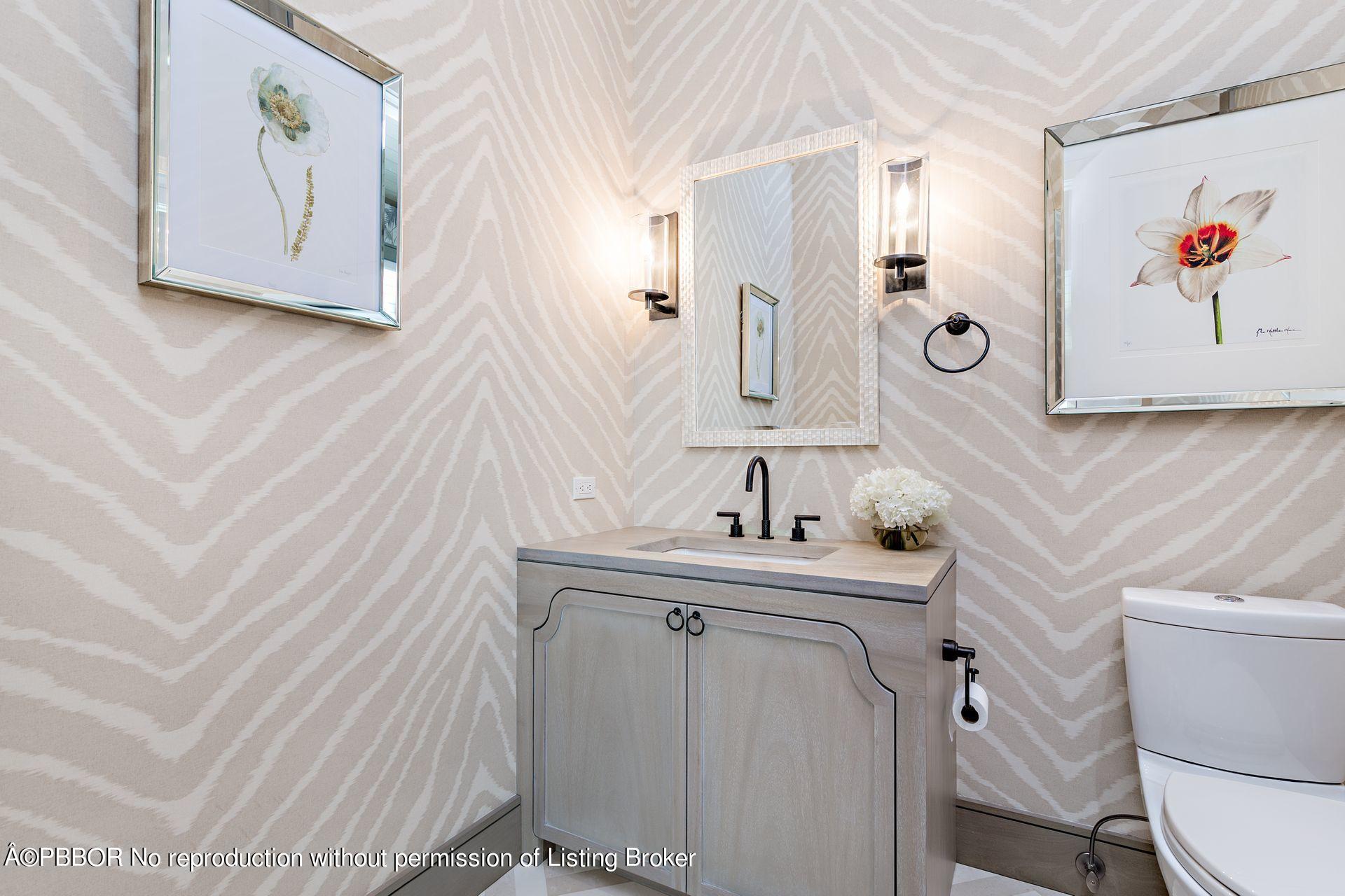 325 Garden Road Palm Beach, FL 33480 - Photo 37 of 57 a bathroom with a sink and a mirror