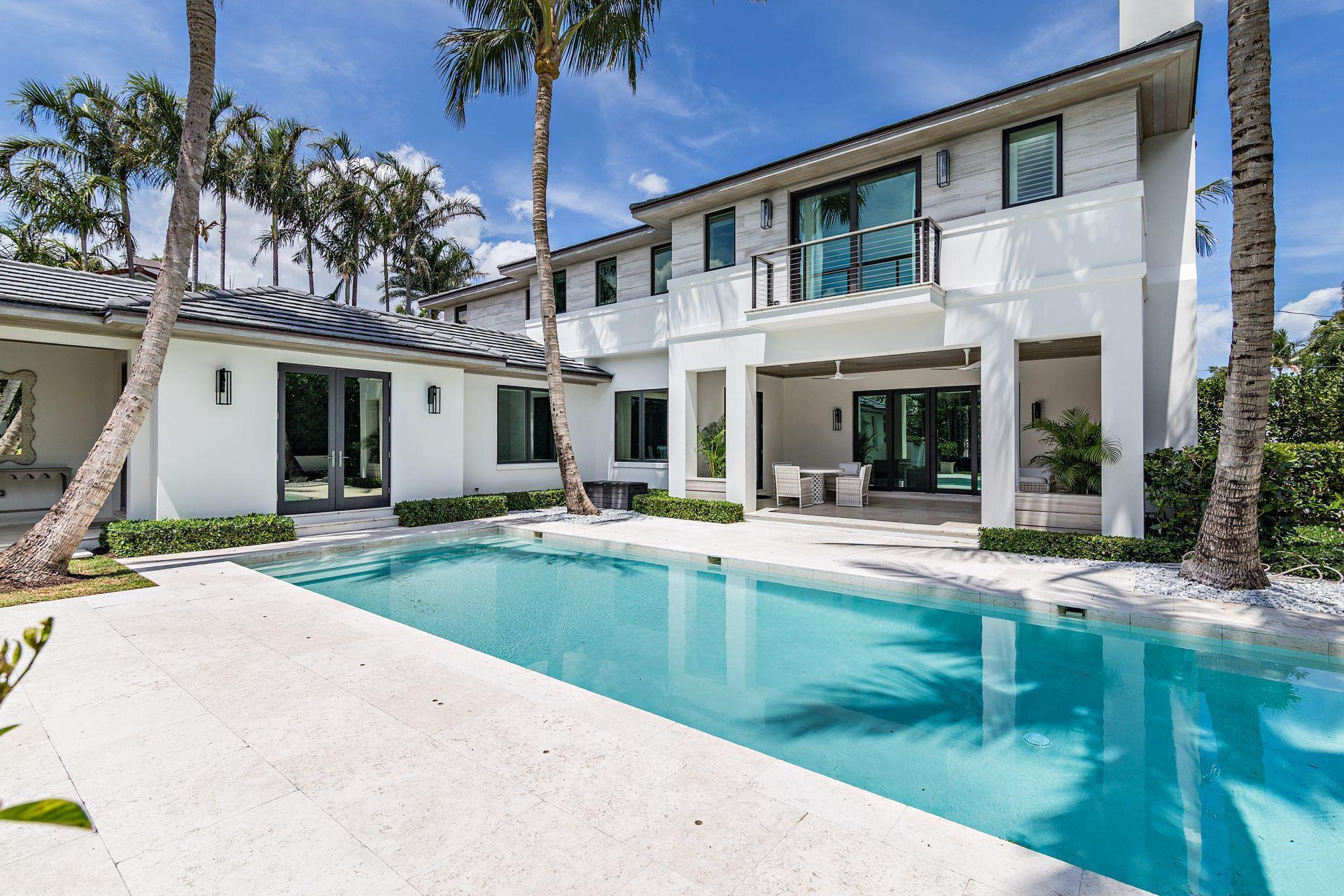 325 Garden Road Palm Beach, FL 33480 - Photo 41 of 57 a view of house with swimming pool and glass windows