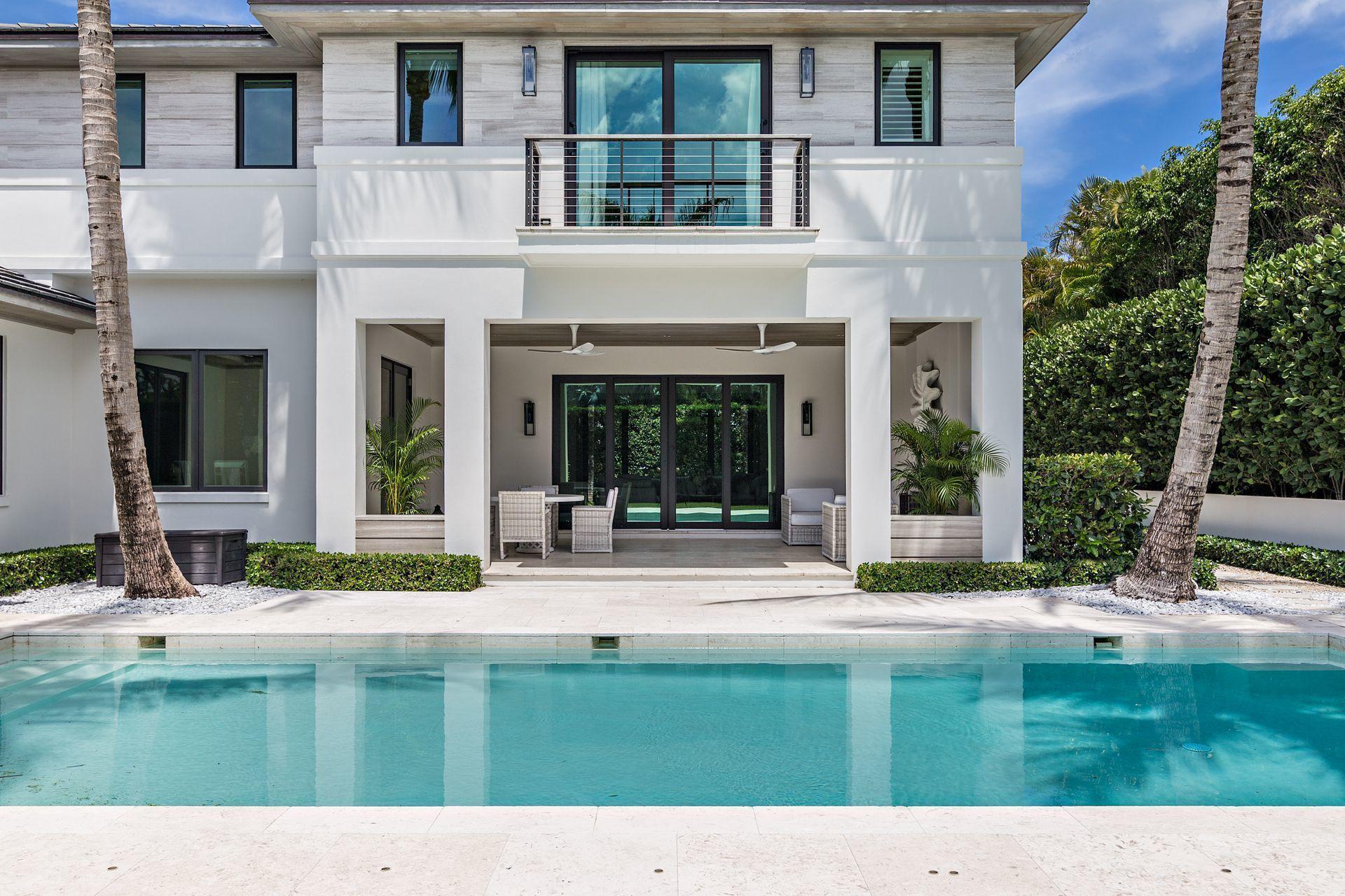 325 Garden Road Palm Beach, FL 33480 - Photo 44 of 57 a swimming pool with outdoor view and trees