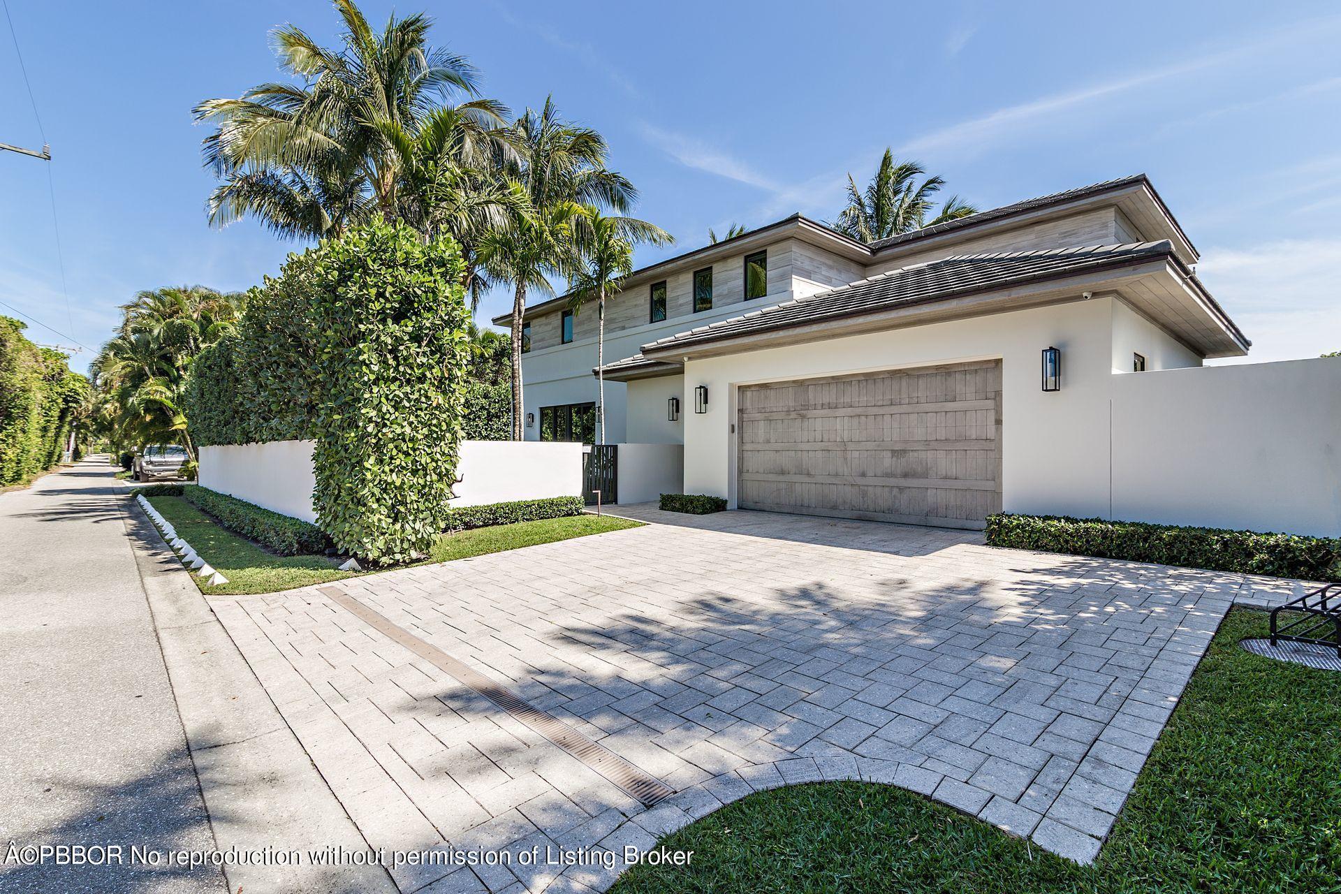 325 Garden Road Palm Beach, FL 33480 - Photo 8 of 57 a front view of a house with a yard and garage