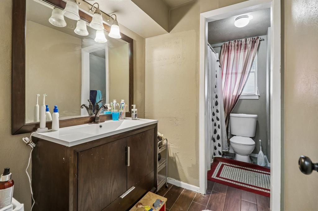 820 North Bowen Road Arlington, TX 76012 - Photo 31 of 40 a bathroom with a sink a toilet and mirror