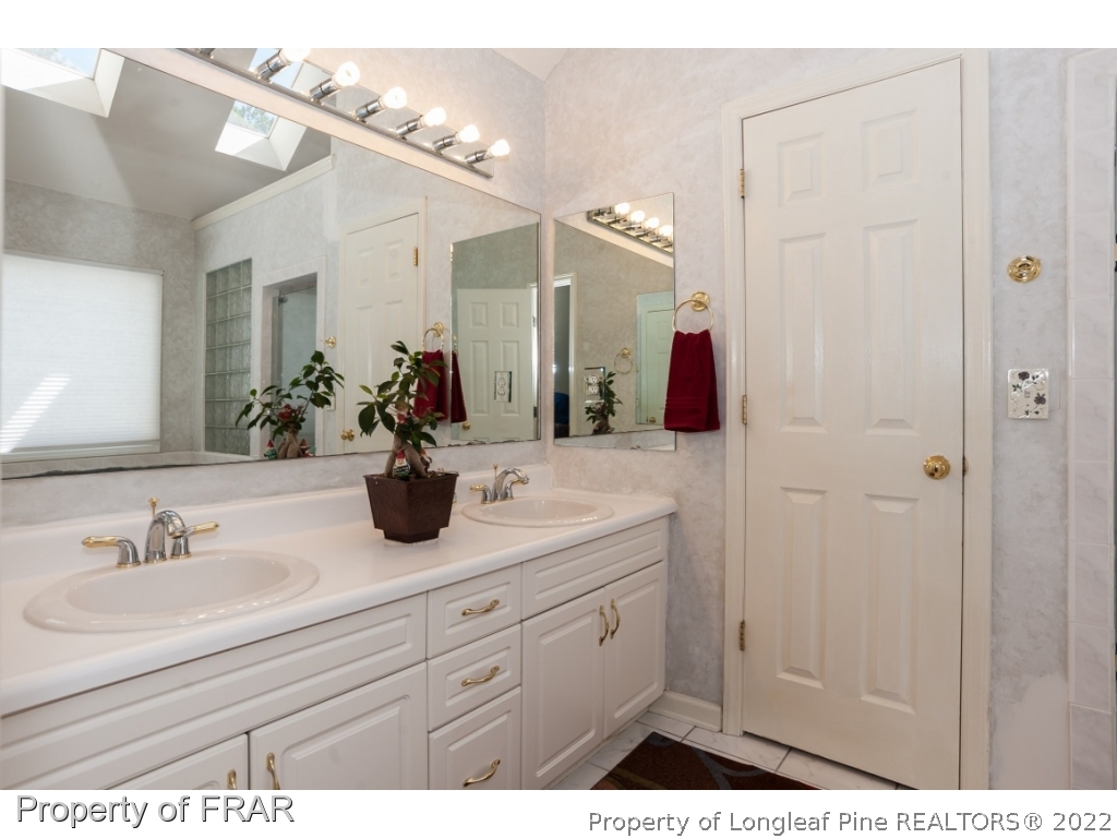 6213 Kirkwall Road Fayetteville, NC 28311 - Photo 11 of 21 a bathroom with a sink and a mirror