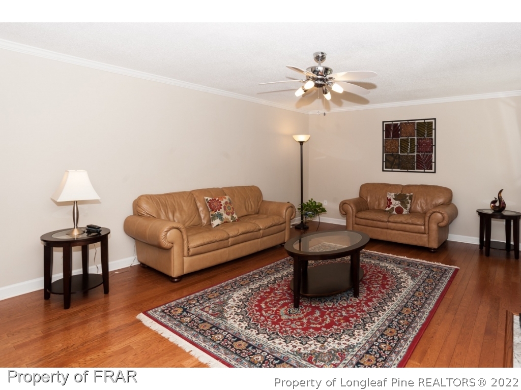 6213 Kirkwall Road Fayetteville, NC 28311 - Photo 3 of 21 a living room with a couch and a chandelier