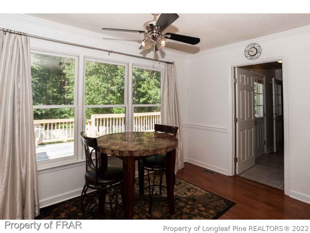 6213 Kirkwall Road Fayetteville, NC 28311 - Photo 7 of 21 a view of a dining room with furniture window and wooden floor
