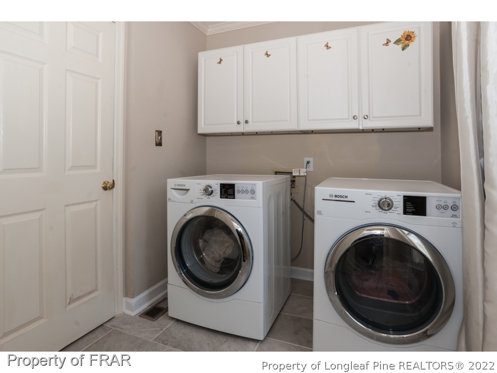6213 Kirkwall Road Fayetteville, NC 28311 - Photo 8 of 21 a view of a hallway with washer and dryer