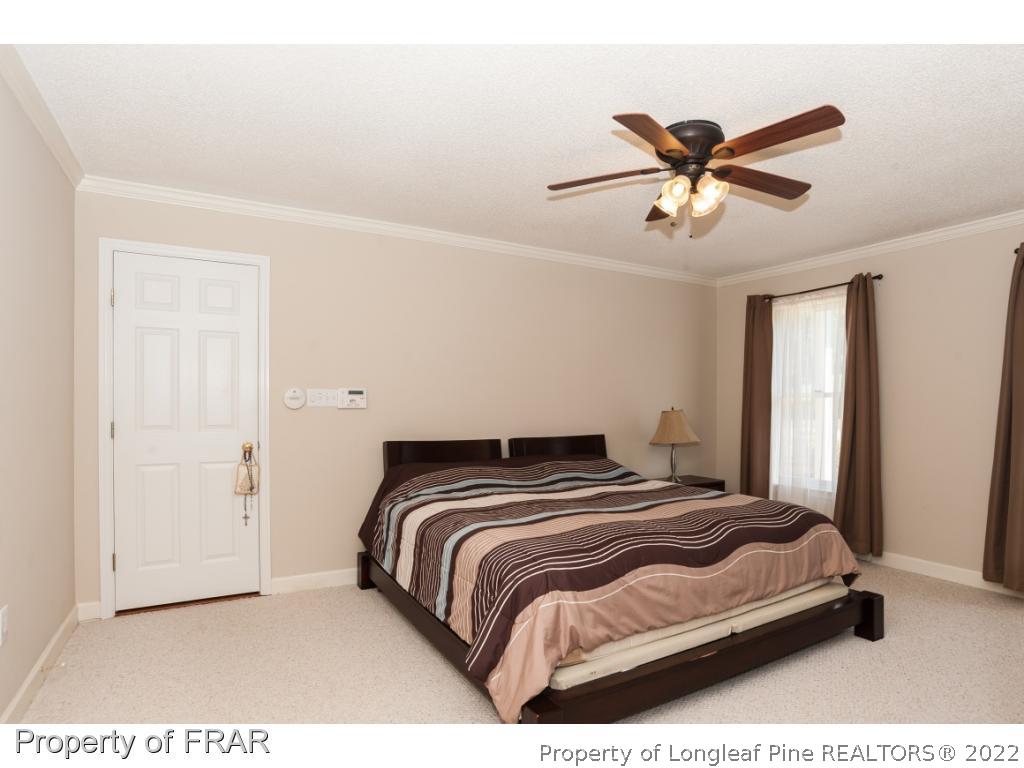 6213 Kirkwall Road Fayetteville, NC 28311 - Photo 10 of 21 a bedroom with a bed and window