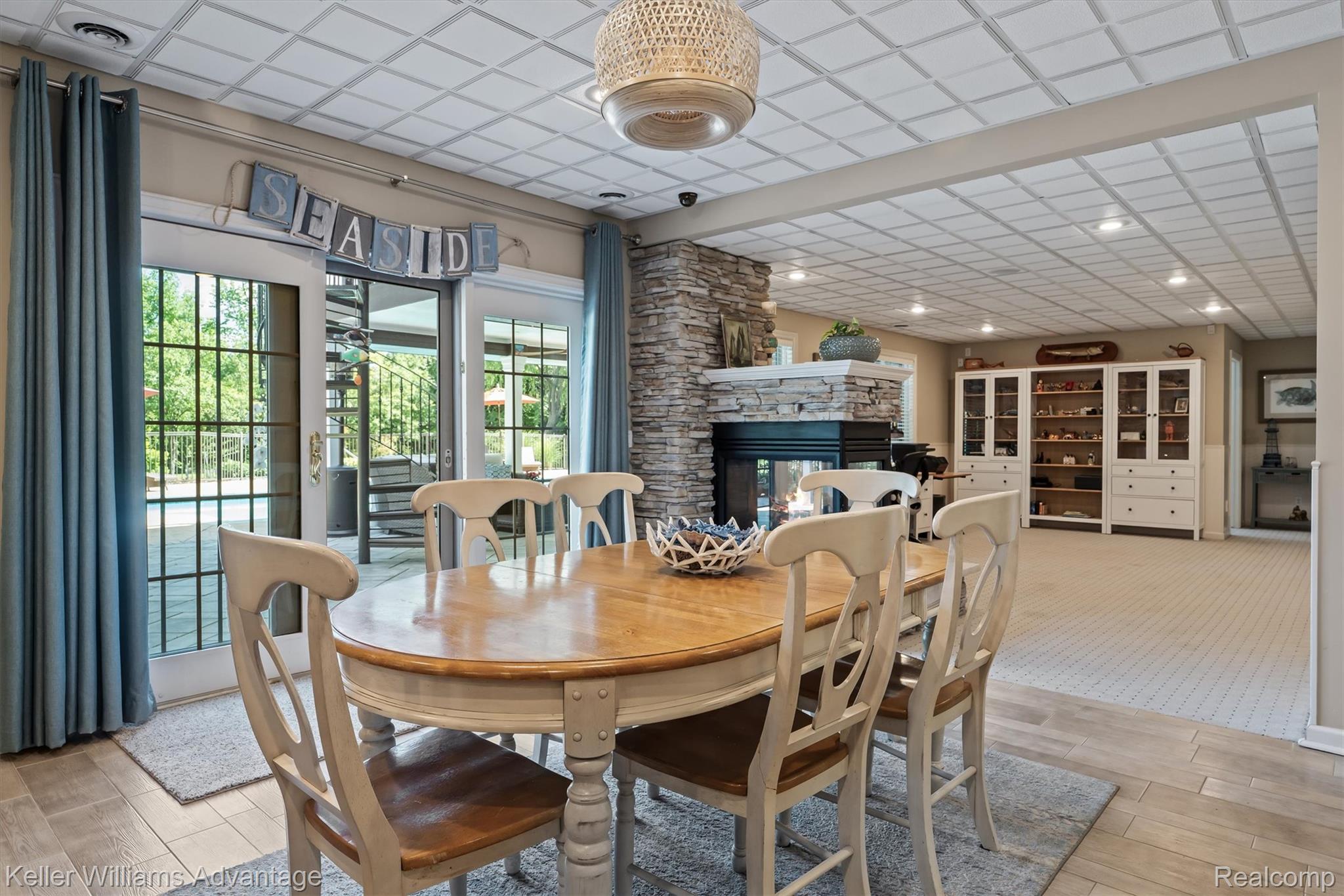 22878 Tree Top Court South Lyon, MI 48178 - Photo 34 of 75 Dining area featuring wood-finish flooring and a tiled ceiling