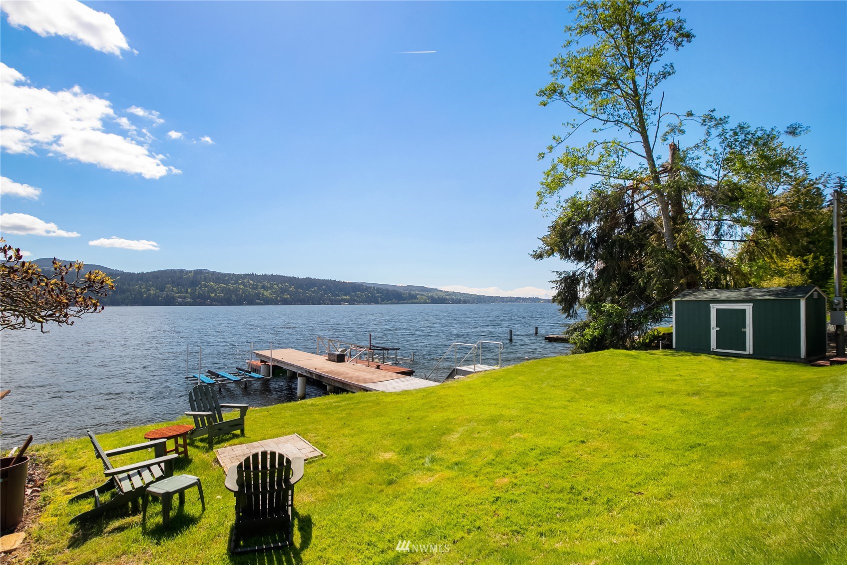 a view of a swimming pool with a patio and a yard