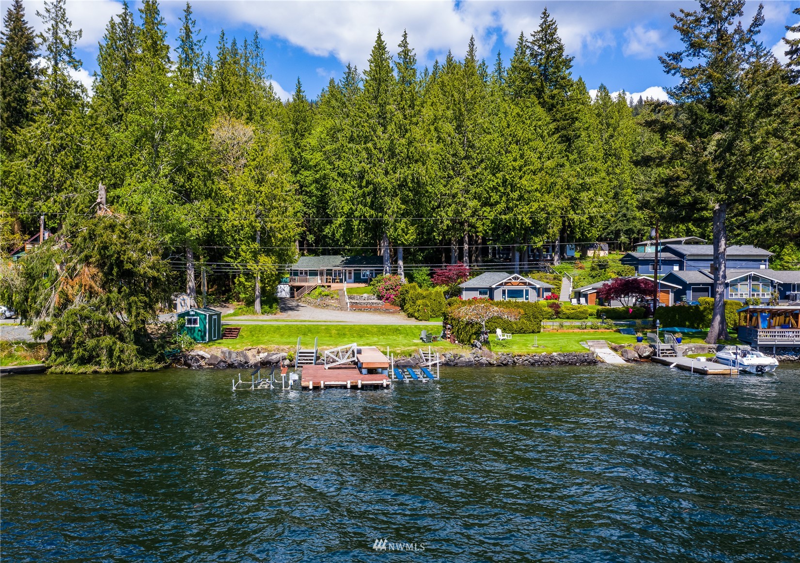2964 North Shore Road Bellingham, WA 98226 - Photo 5 of 40 a view of a swimming pool with lawn chairs under an umbrella