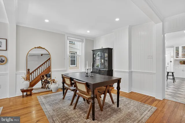 a kitchen with a dining table cabinets appliances and a window