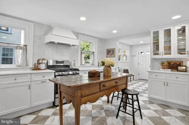 a kitchen with granite countertop a stove and a sink