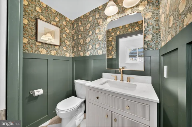 a spacious bedroom with a bed and wooden floor