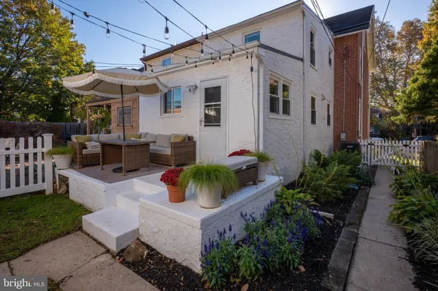 a backyard of a house with table and chairs