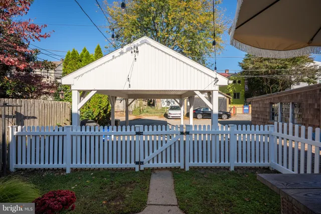 a living room with furniture and a dining table with wooden floor
