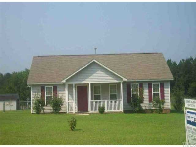 1333 Lee Road Clayton, NC 27520 - Photo 1 of 1 a front view of a house with a yard table and chairs